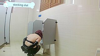 hot blonde gives femdom handjob while sitting toilet